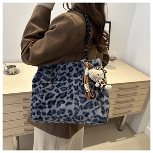 Close-up of leopard print faux fur shoulder bag with black chain and cute cat charm