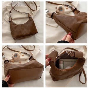 Detailed views of a brown pleated crescent underarm bag with a lion plush charm