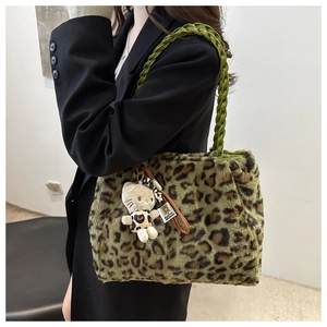 Close-up of leopard print plush tote bag featuring bright green braided leather handles