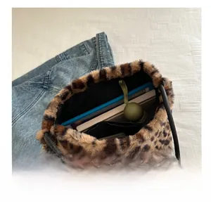 Macro view showing large capacity of leopard print plush tote bag with inner storage space