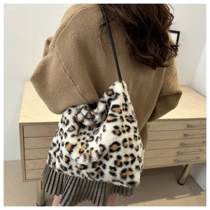Detail of soft leopard print faux fur tote bag showing plush texture and black strap