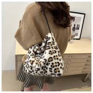 Detailed side view of leopard print faux fur tote bag with slim black shoulder strap