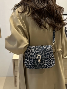 Leoparden-Umhängetasche mit goldener Hufeisenschnalle und verstellbarem Riemen am Modell