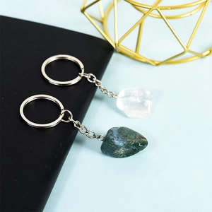 Natural crystal keychains featuring clear quartz and green moss agate with silver metal rings
