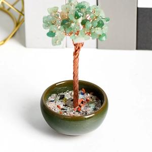 Natural crystal money tree with green aventurine leaves in a dark green ceramic bowl