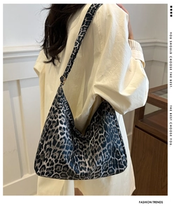 Detailed model shot of the large leopard print tote bag showing texture and drape