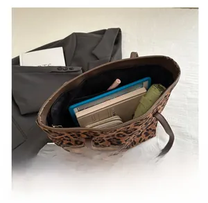 Top view of large leopard print tote bag interior showing spacious storage capacity