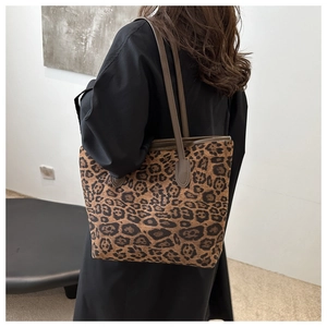 Detailed view of large tote bag featuring classic leopard print and slim shoulder straps