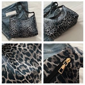 Detail view of leopard print tote bag with pebbled texture and gold zipper hardware