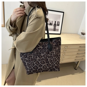 Detail of leopard print tote bag styled with a khaki trench coat for a chic daily look