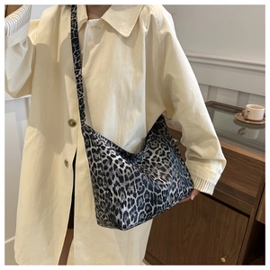 Detailed view of leopard print canvas hobo bag showing large capacity and wide shoulder strap