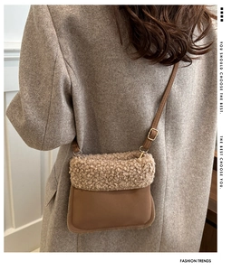 Detail view of brown faux suede bucket bag with soft fleece trim and slim shoulder strap