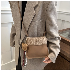 Détail du sac seau en daim avec bordure en polaire et charmant ours en peluche