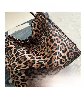 Close-up of leopard print canvas tote bag showing pebble grain texture and durable material