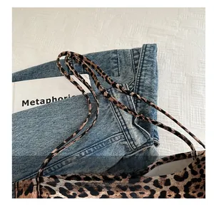 Detail view of leopard print tote bag straps with reinforced stitching on canvas fabric