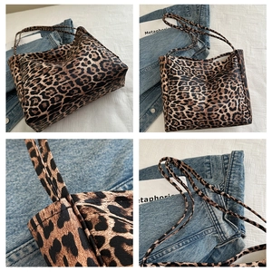 Detail view of the leopard print pattern and slim shoulder straps on the tote bag