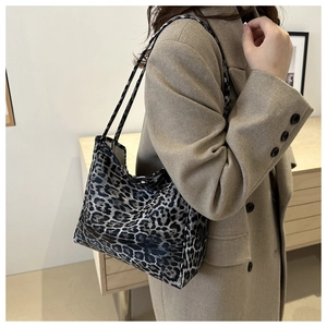 Side view of leopard print tote bag styled with a khaki coat for autumn winter fashion