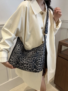 Leopard print canvas tote bag with adjustable strap for women in a stylish lifestyle setting