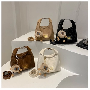 Close-up of four colors of large nylon handbags with cute plush sheep pendants