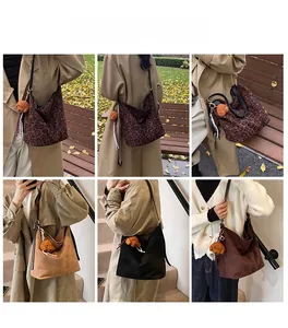 Detailed view of leopard print tote bag featuring a cute brown teddy bear plush charm