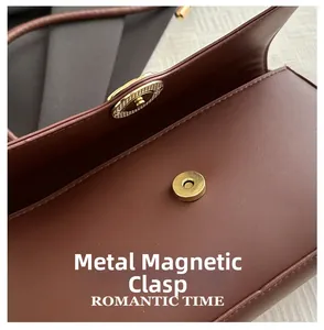 Detail of premium brown leather texture with golden magnetic clasp and fine stitching
