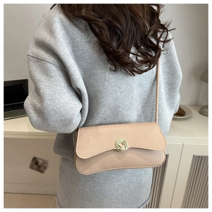 Minimalist beige shoulder bag with gold circular twist buckle and chain strap for women
