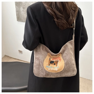 Detailed back view of a brown corduroy crossbody bag with a cute cat embroidery patch