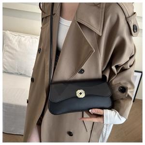 Minimalist black underarm bag with gold flower buckle and thin leather shoulder strap