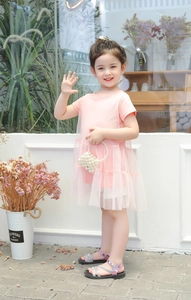 Detail of baby girl summer dress featuring pink mesh tulle skirt and soft cotton top