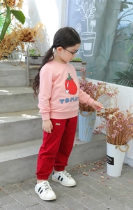 Detailed close-up of pink long sleeve tomato print sweatshirt and red cotton jogger set
