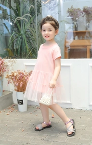 Detail of pink girls princess dress with layered organza tulle skirt and pearl bag