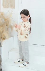 Detail of toddler girl long sleeve sweatshirt set with cute bear print and grey joggers
