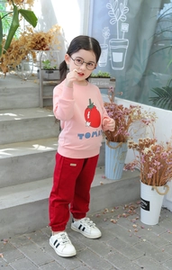 Detail of pink cotton sweatshirt with tomato print and matching red joggers for girls
