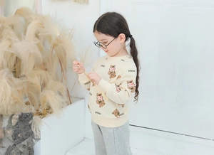 Detail view of cotton teddy bear print sweatshirt and grey pants on child model