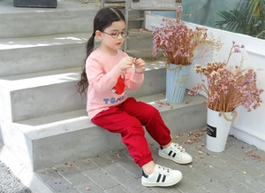 Detail of toddler girls pink cotton sweatshirt with tomato print and red joggers