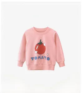 Detailed view of pink cotton sweatshirt with a red tomato print and ribbed cuffs