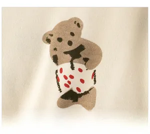 Detailed close-up of a cartoon bear print on beige cotton fabric for a kid sweater