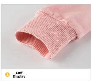Detail shot of the ribbed pink cuffs on a children's cotton sweatshirt for girls
