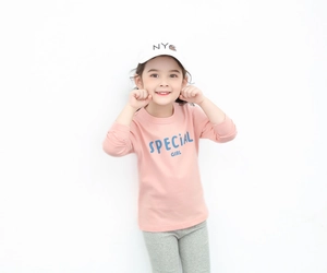 Detail of soft cotton pink long sleeve t-shirt with SPECIAL GIRL blue lettering print