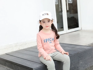 Detailed shot of girl's pink long sleeve tee with blue 'Special Girl' text print