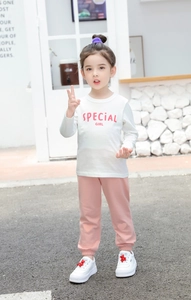 Detail of girls cotton long sleeve t-shirt and pink joggers set with Special Girl text