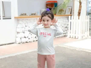 Detail of girls cotton long sleeve t-shirt and pink pants with Special Girl print