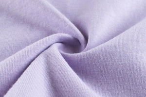 Macro shot of soft lavender knit fabric texture showing premium cotton material detail