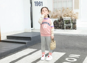 Outdoor shot of girls patchwork sweatshirt with Morning 82 print and grey jogger pants