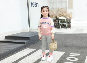 Detail of toddler girl pink color-block sweatshirt with MORNING 82 print and grey leggings