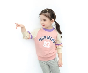 Close-up of pink and cream color-block sweatshirt featuring MORNING 82 print design