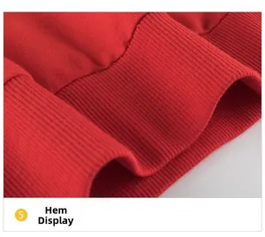 Close-up of the ribbed hem on a red knitted sweatshirt showing fabric texture and detail