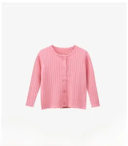 Detail of pink knitted cardigan for girls featuring ribbed texture and five matching buttons