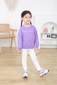 Detail of purple girls' sweatshirt featuring Humans are born good slogan print