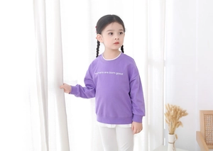 Detail of purple cotton sweatshirt for girls with 'Humans are born good' graphic print
